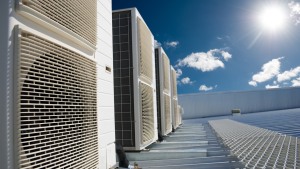 industrial air conditioner units on a rooftop under a hot summer sun